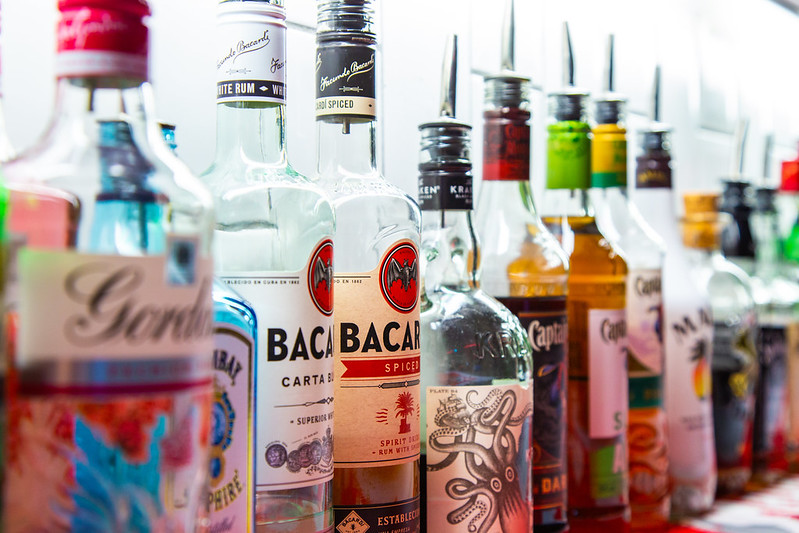 A close up of bottles of spirits, including Bacardi and Captain Morgan rum