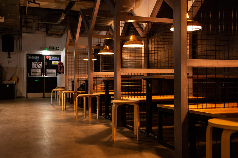 Raised booths separated by mesh screens