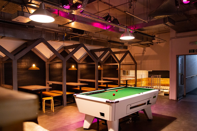 A better view of the pool table and raised booths