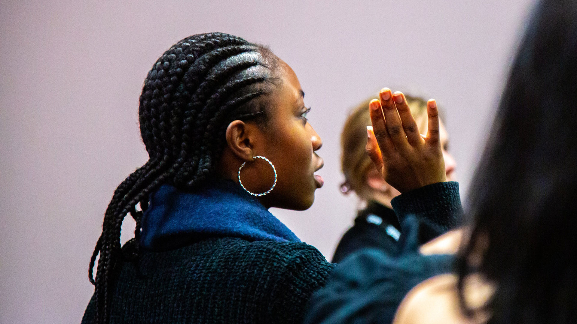 A photograph of a student asking a question at the Annual Members Meeting 2022